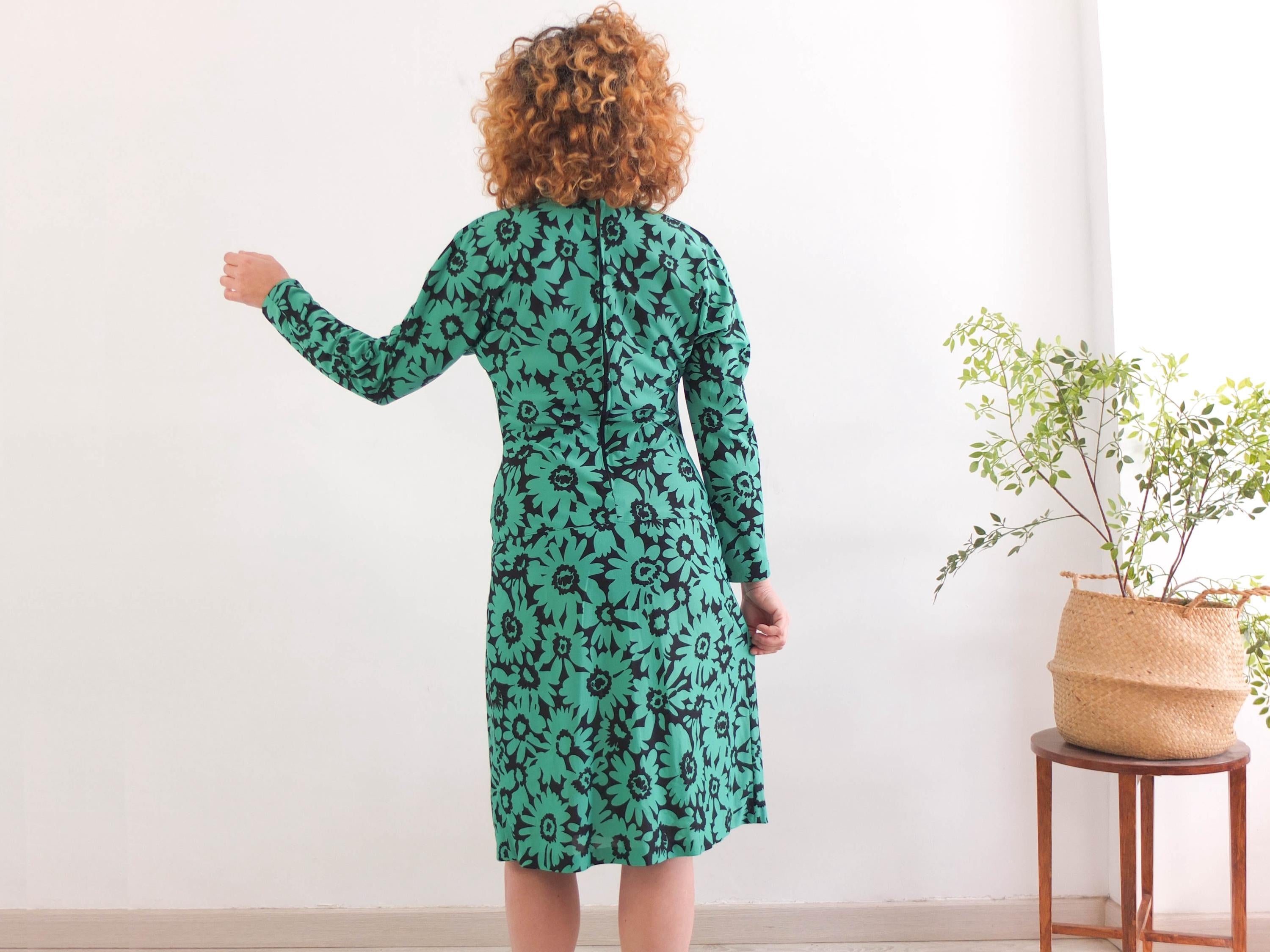 The 1980s draped evening blouson dress is polyester fabric with back zipper closure, in excellent vintage condition by Francine.